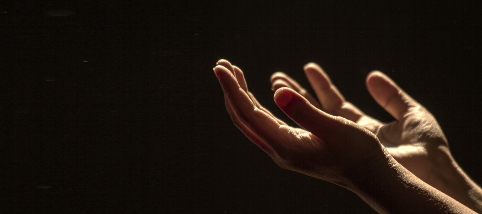 Open hands lifted in prayer